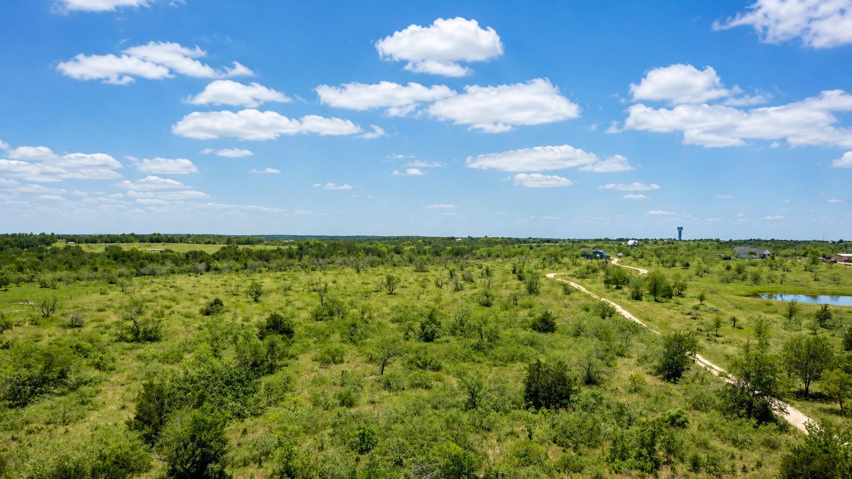 Vast green acreage unfolds under a wide-open sky,