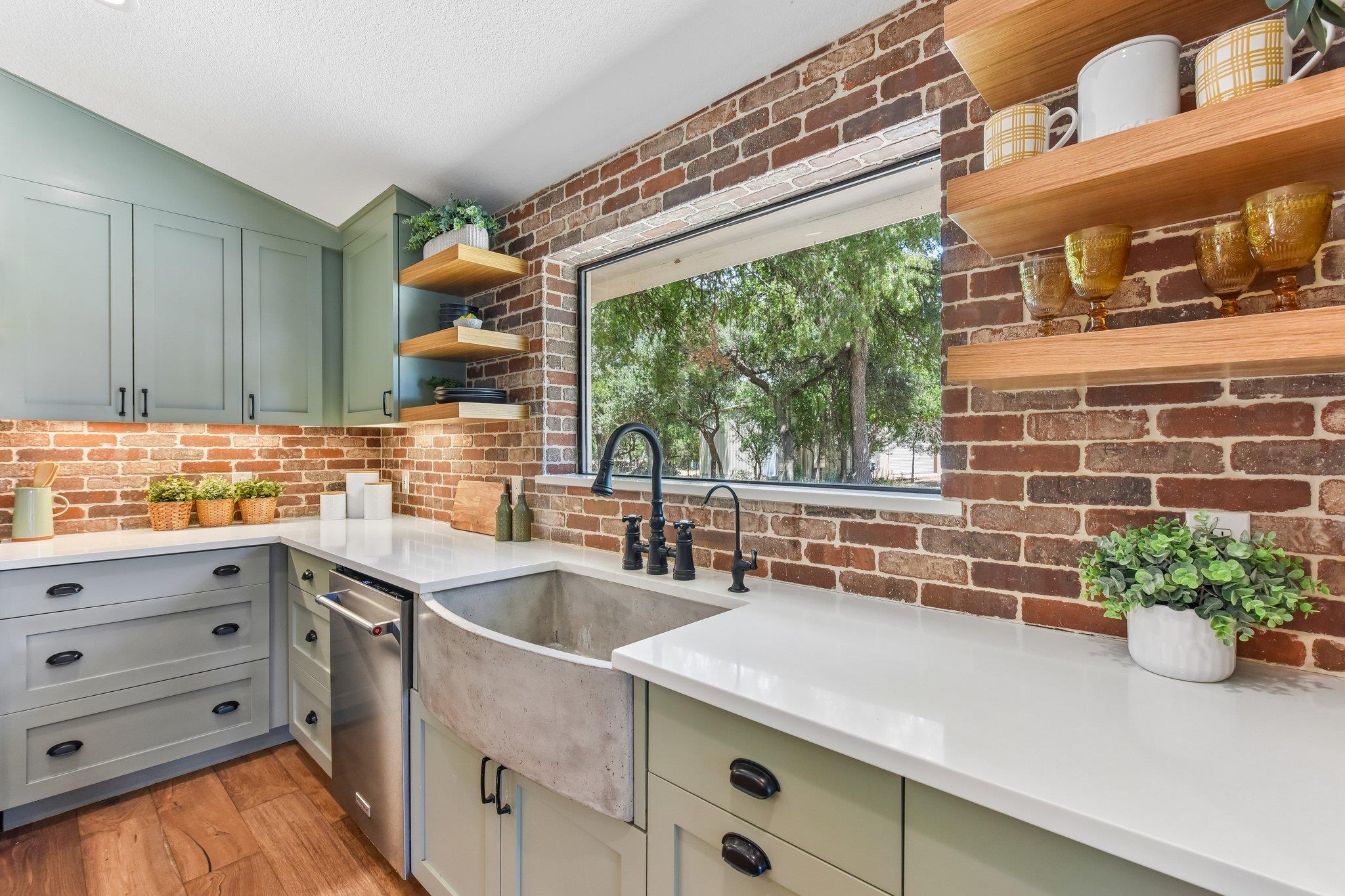 An inviting kitchen features a farmhouse sink, br