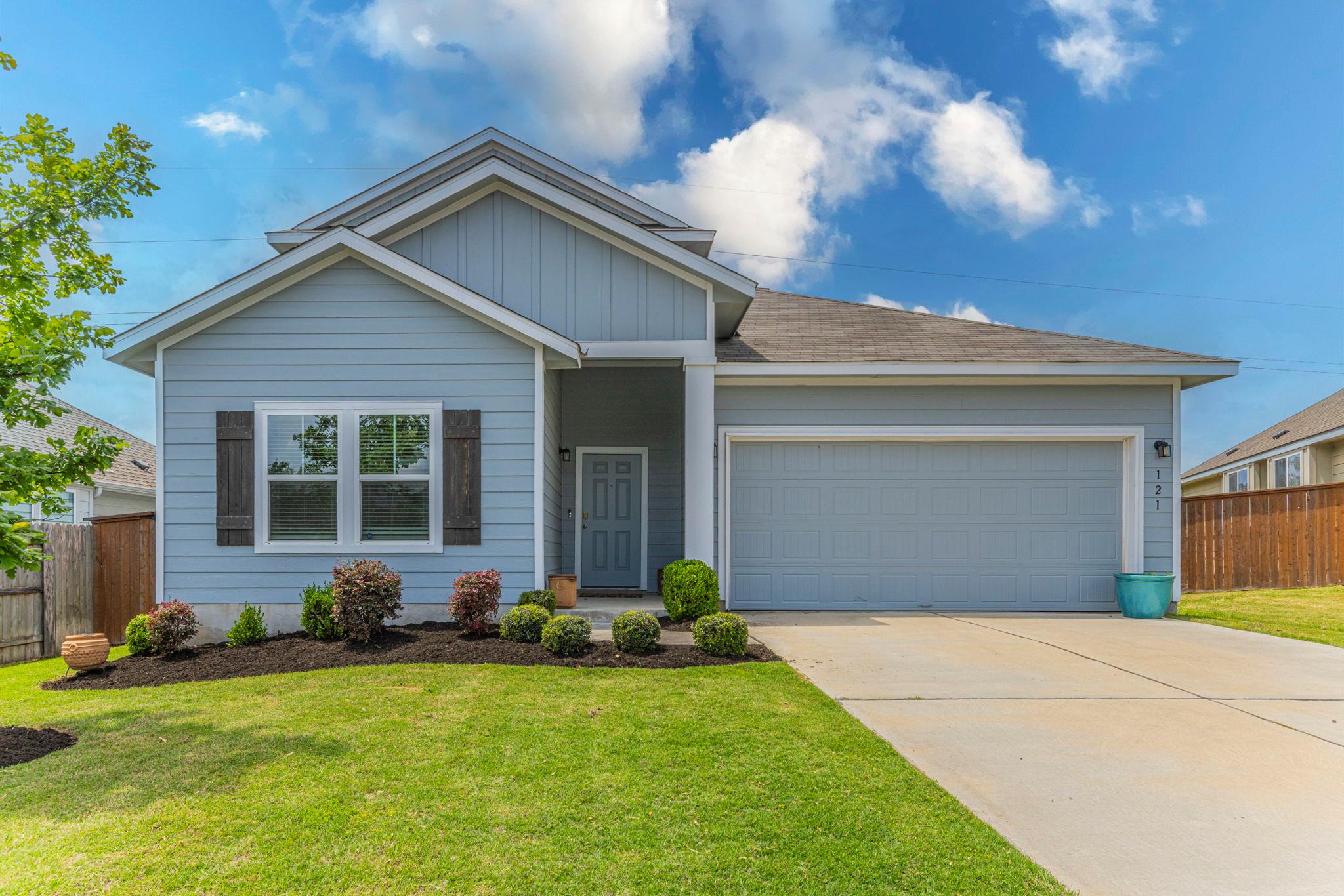 The property features a light blue exterior, a we