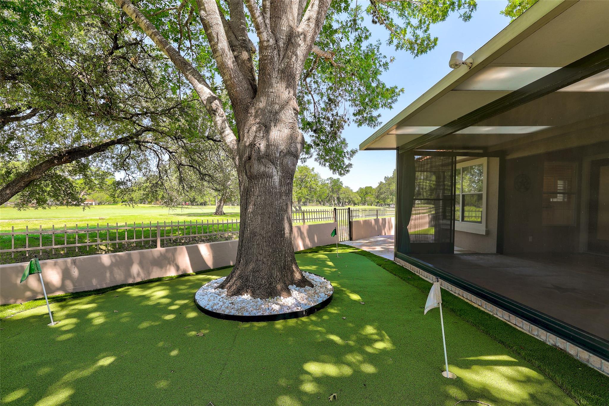 A private putting green extends from the covered 