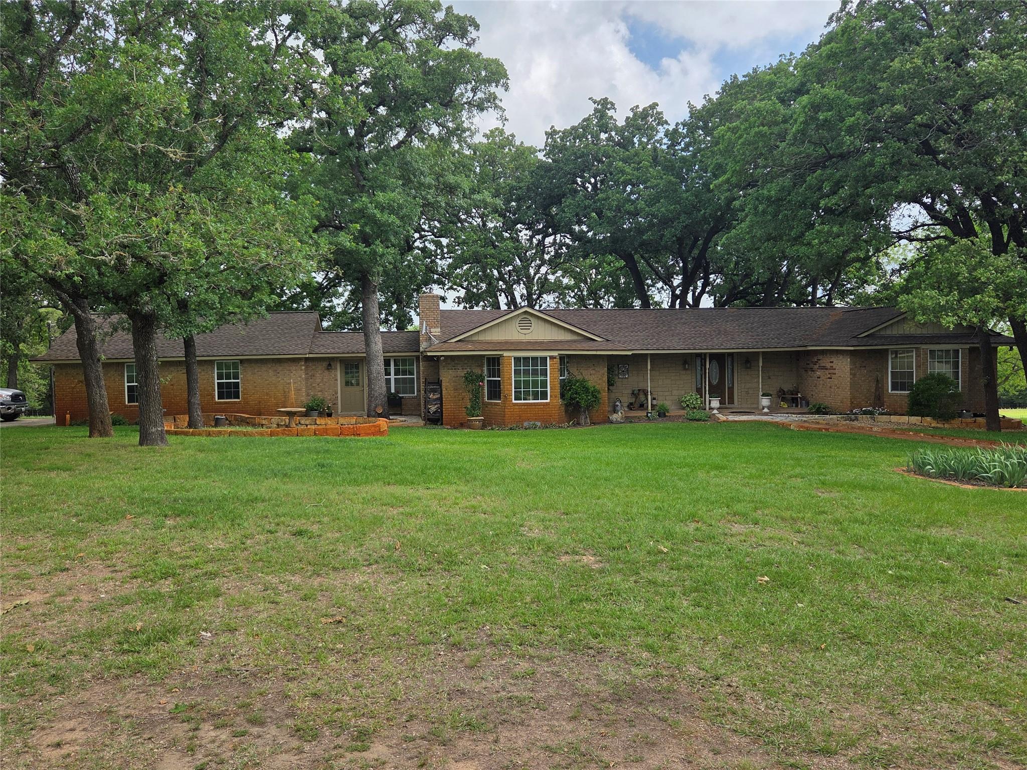 The property features a brick exterior, a covered