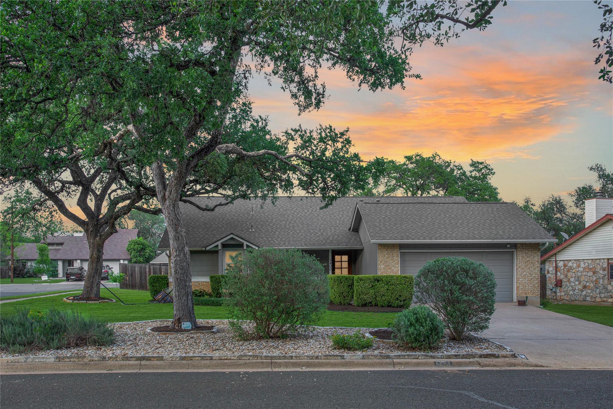 Single-story residence featuring a gray asphalt s