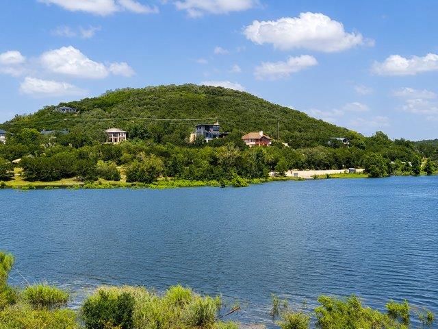 Houses dot the verdant hillside overlooking a tra