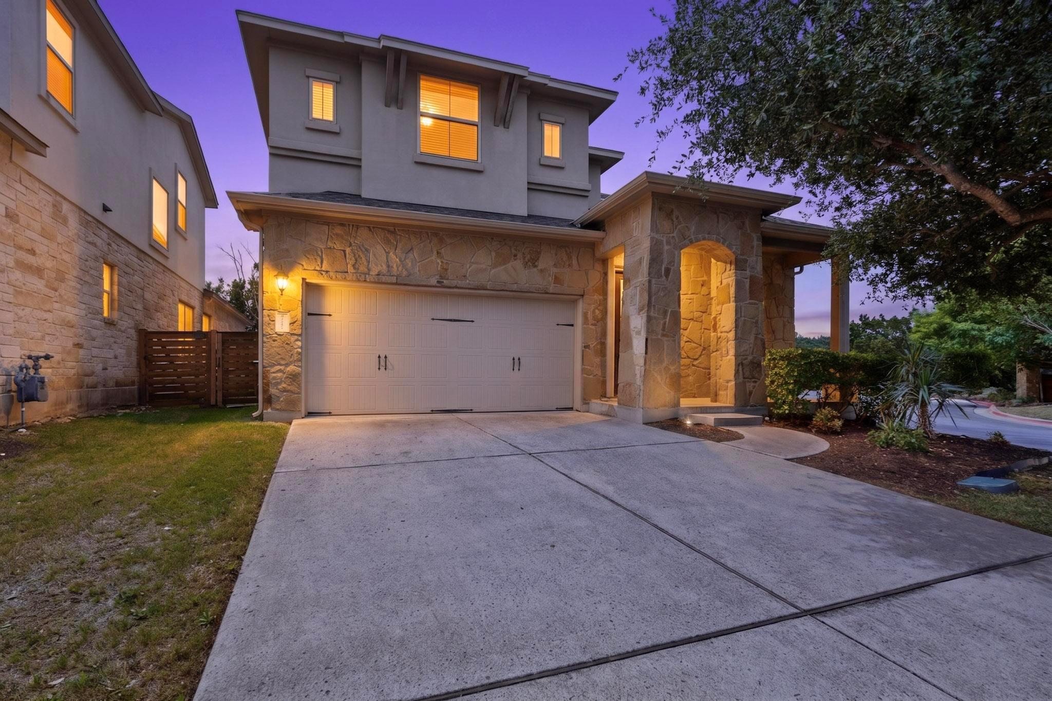 Stone veneer exterior with stucco accents, featur