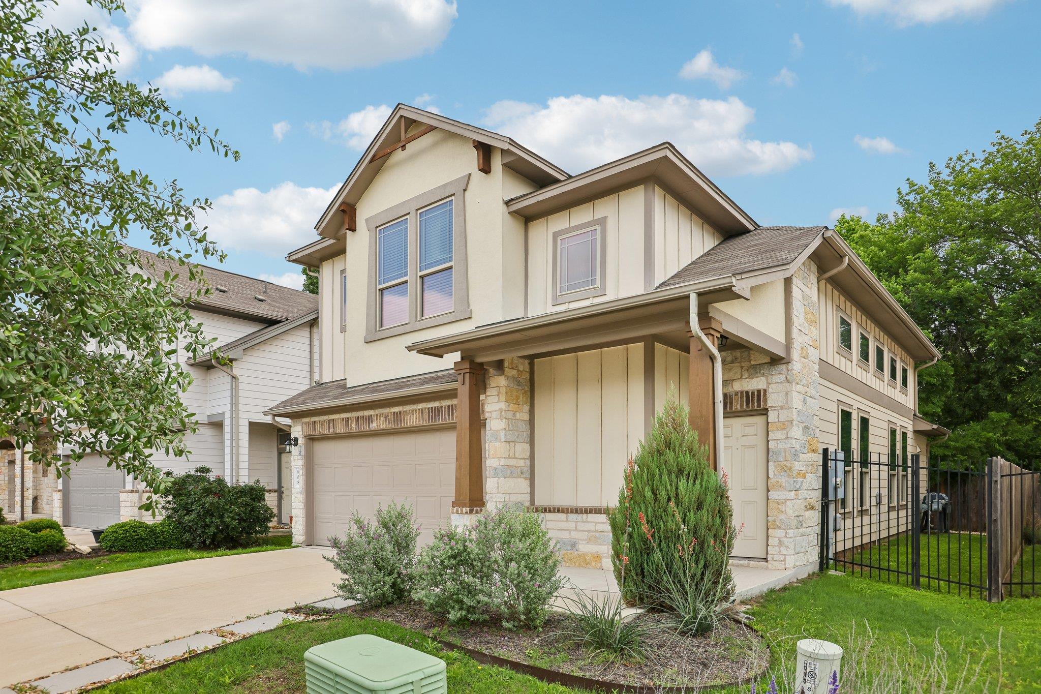 Contemporary two-story residence featuring a ston