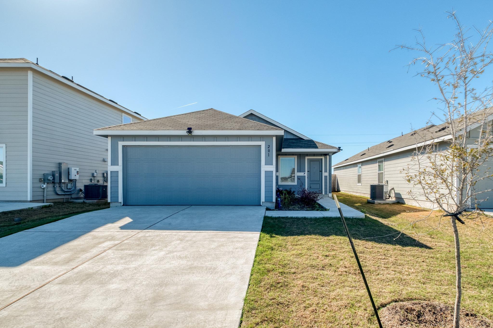 The property features a concrete driveway and an 