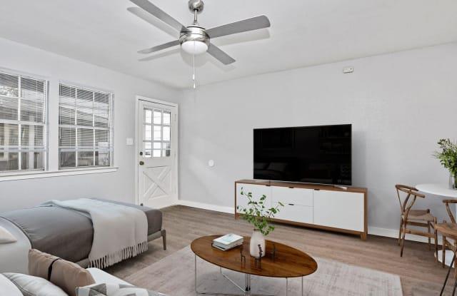 The living area features light-toned walls, wood-