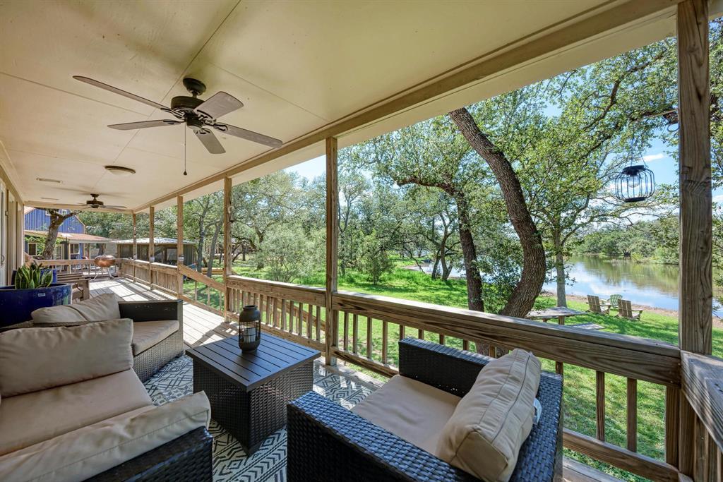 Expansive covered porch with ceiling fans, offeri
