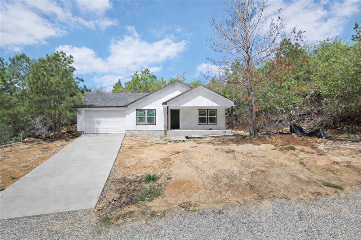 The property features a white exterior, a dark sh