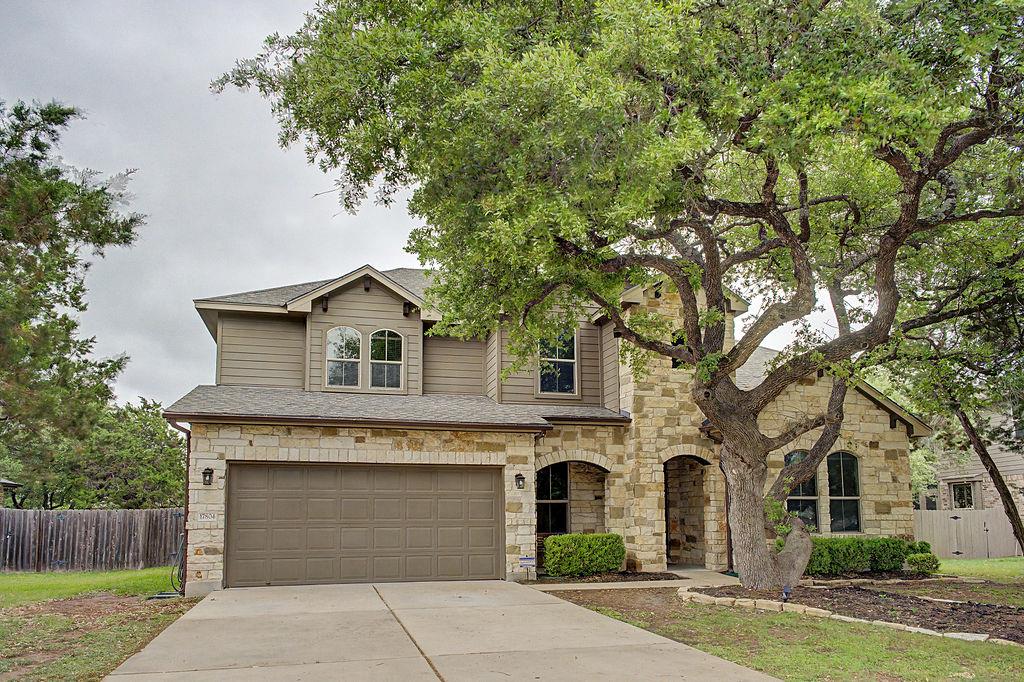 The property features a stone and siding exterior