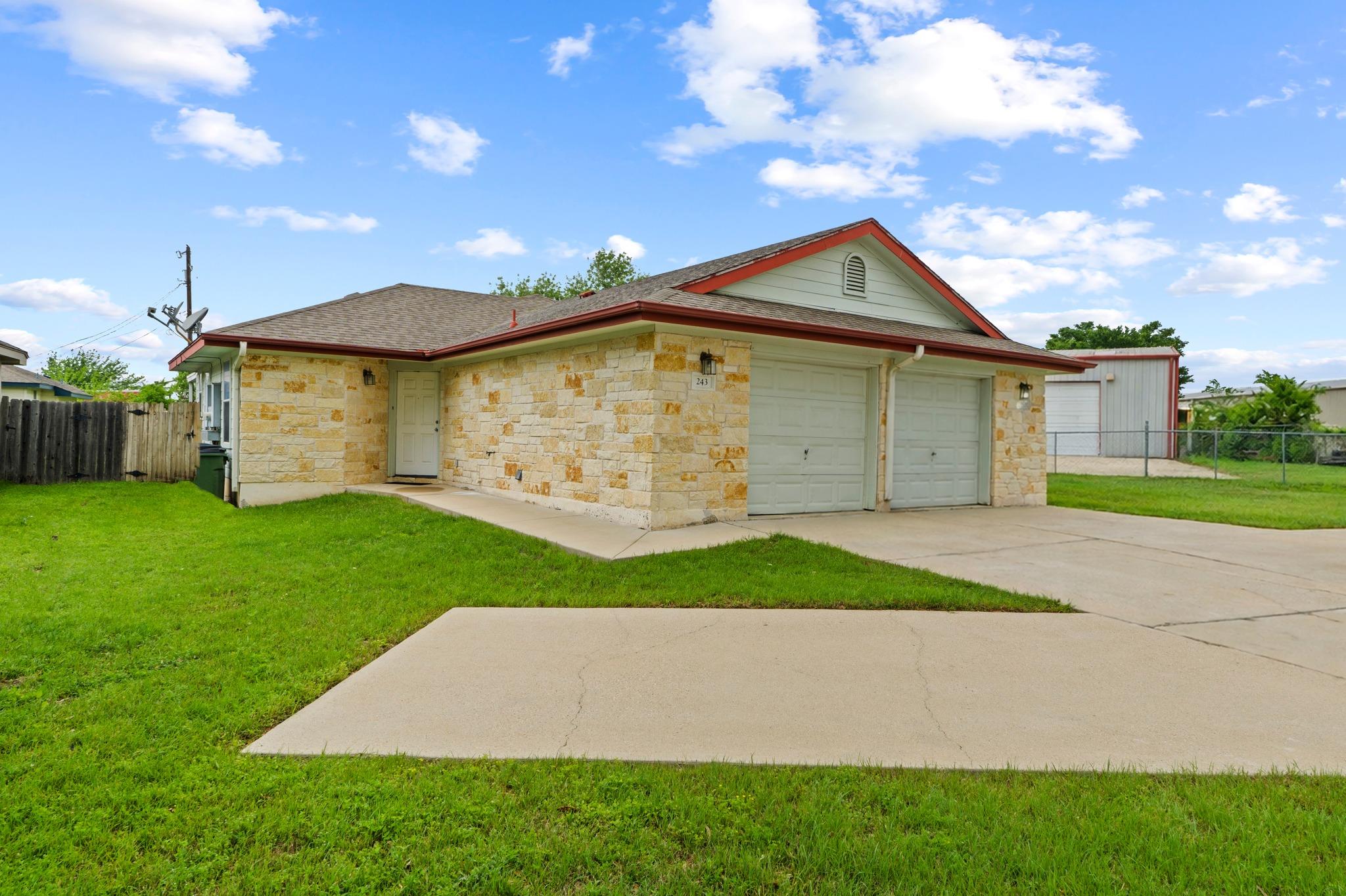 The property features a stone facade, a two-car g