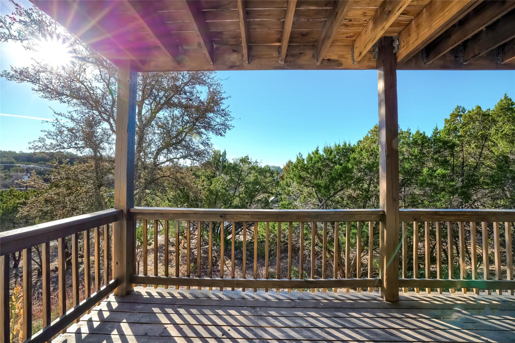 The property features a wooden deck with a wooden