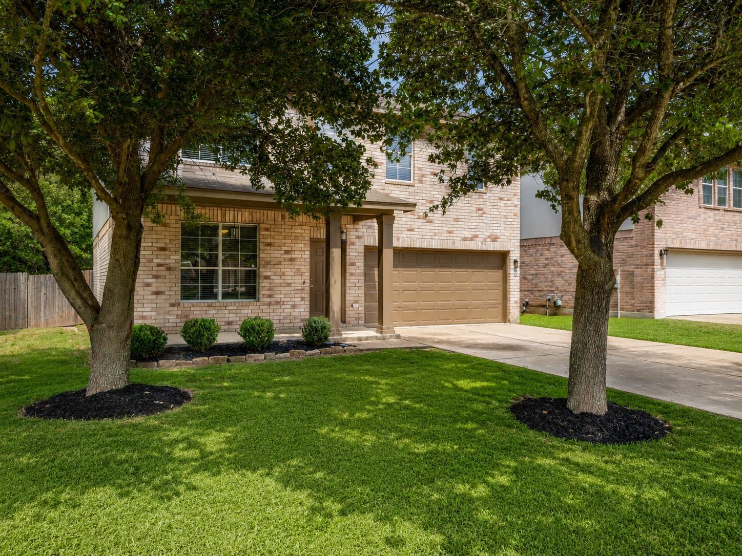Brick facade residence featuring a covered entry 
