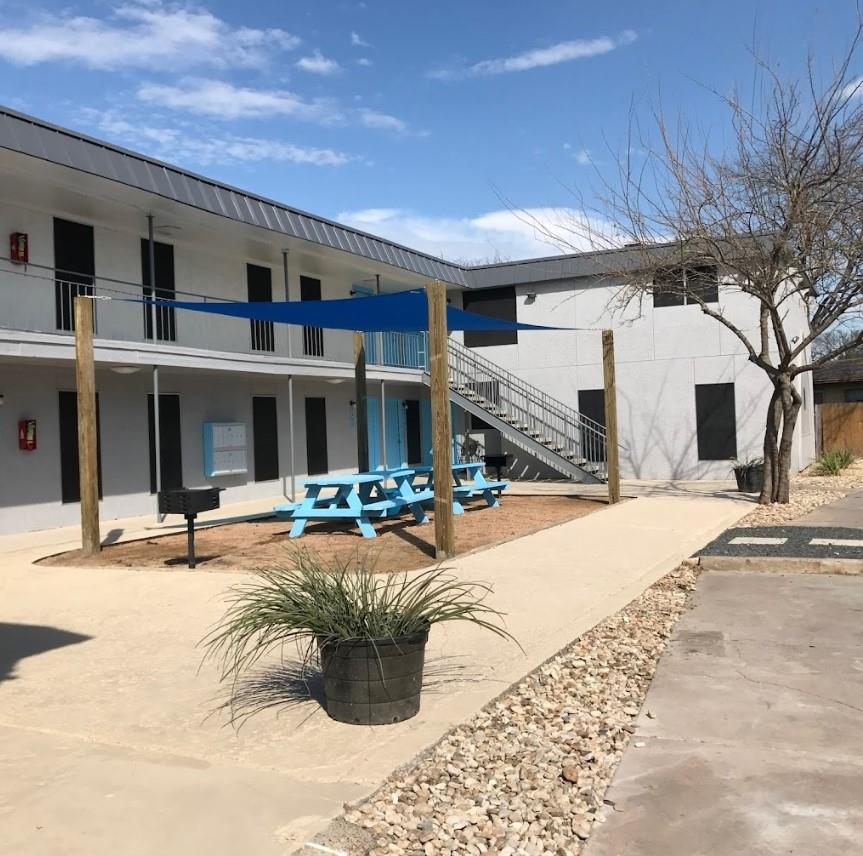The property features a courtyard area with concr