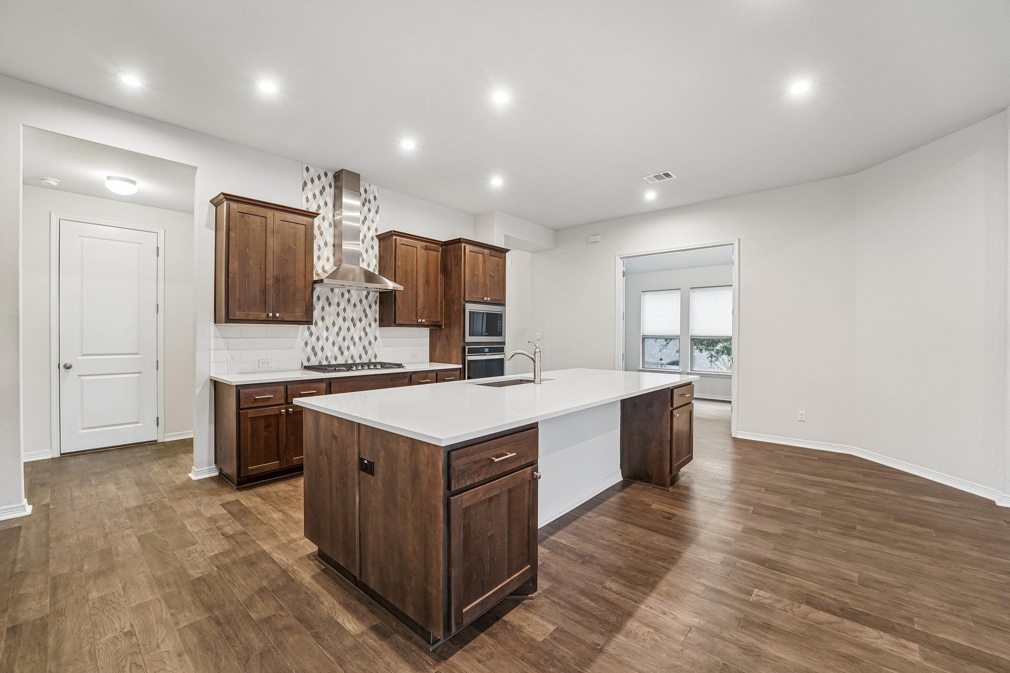 Spacious kitchen featuring an expansive center is