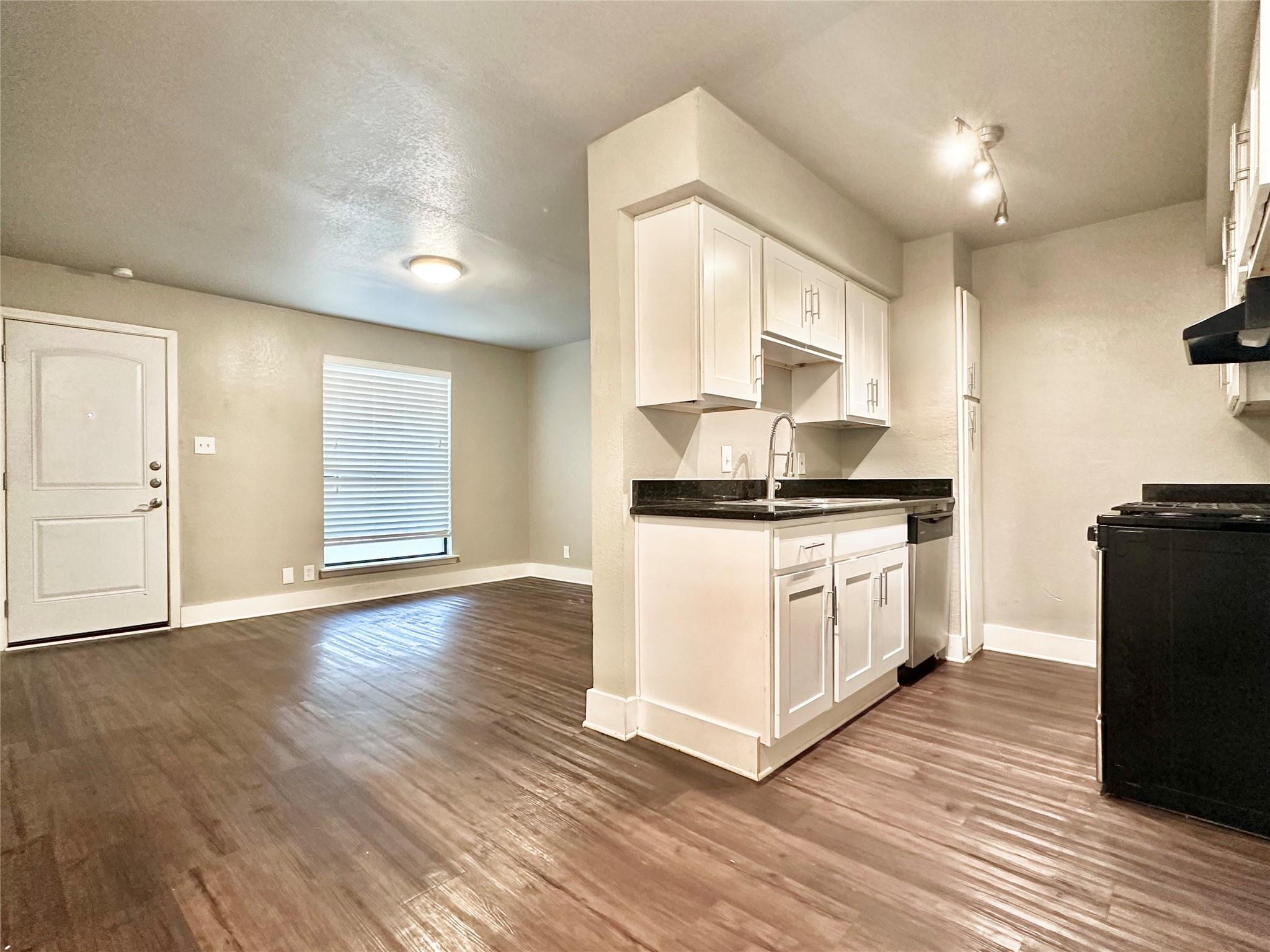 The property features wood flooring, a kitchen wi