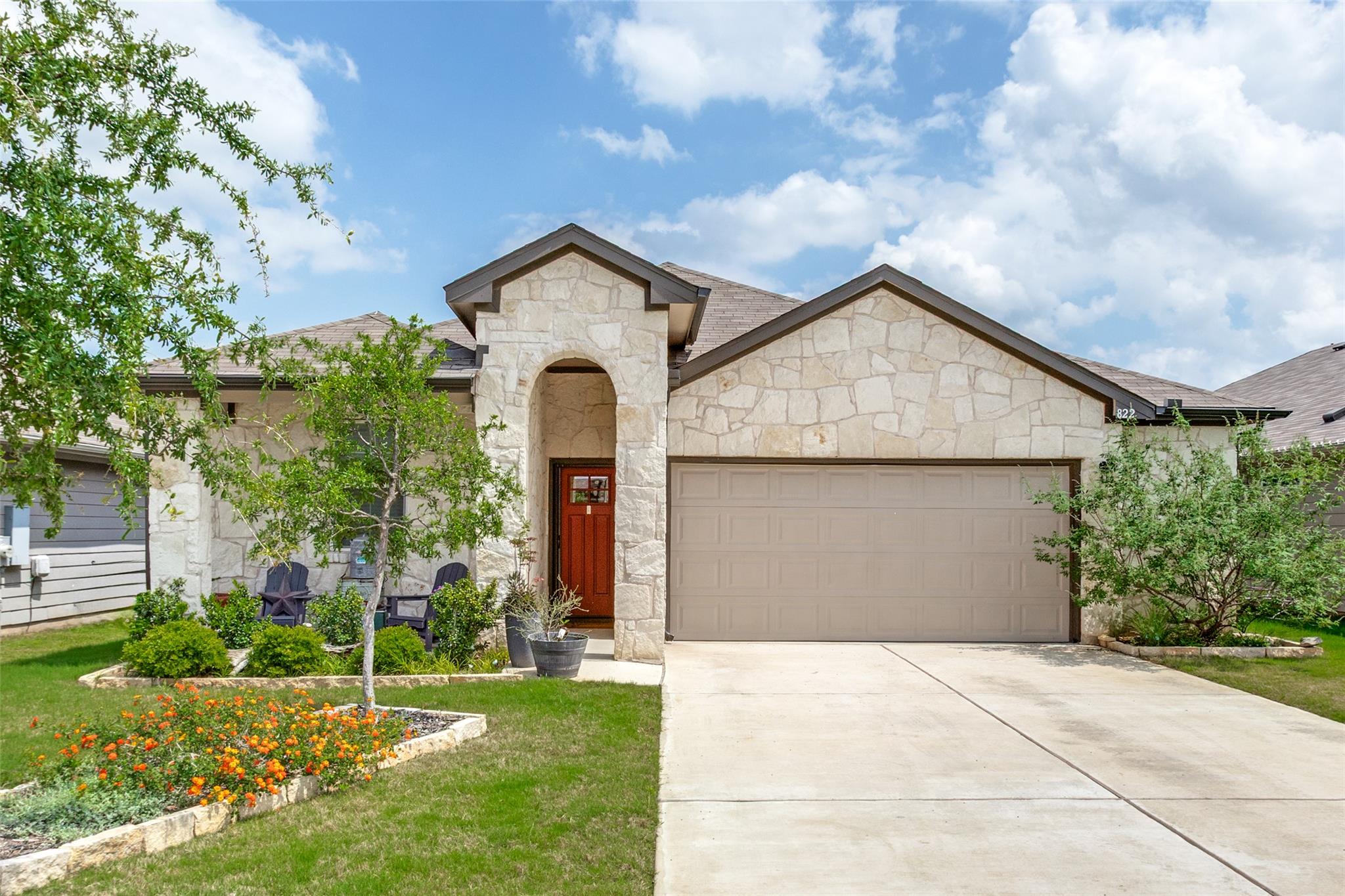The property features a stone facade, an arched e
