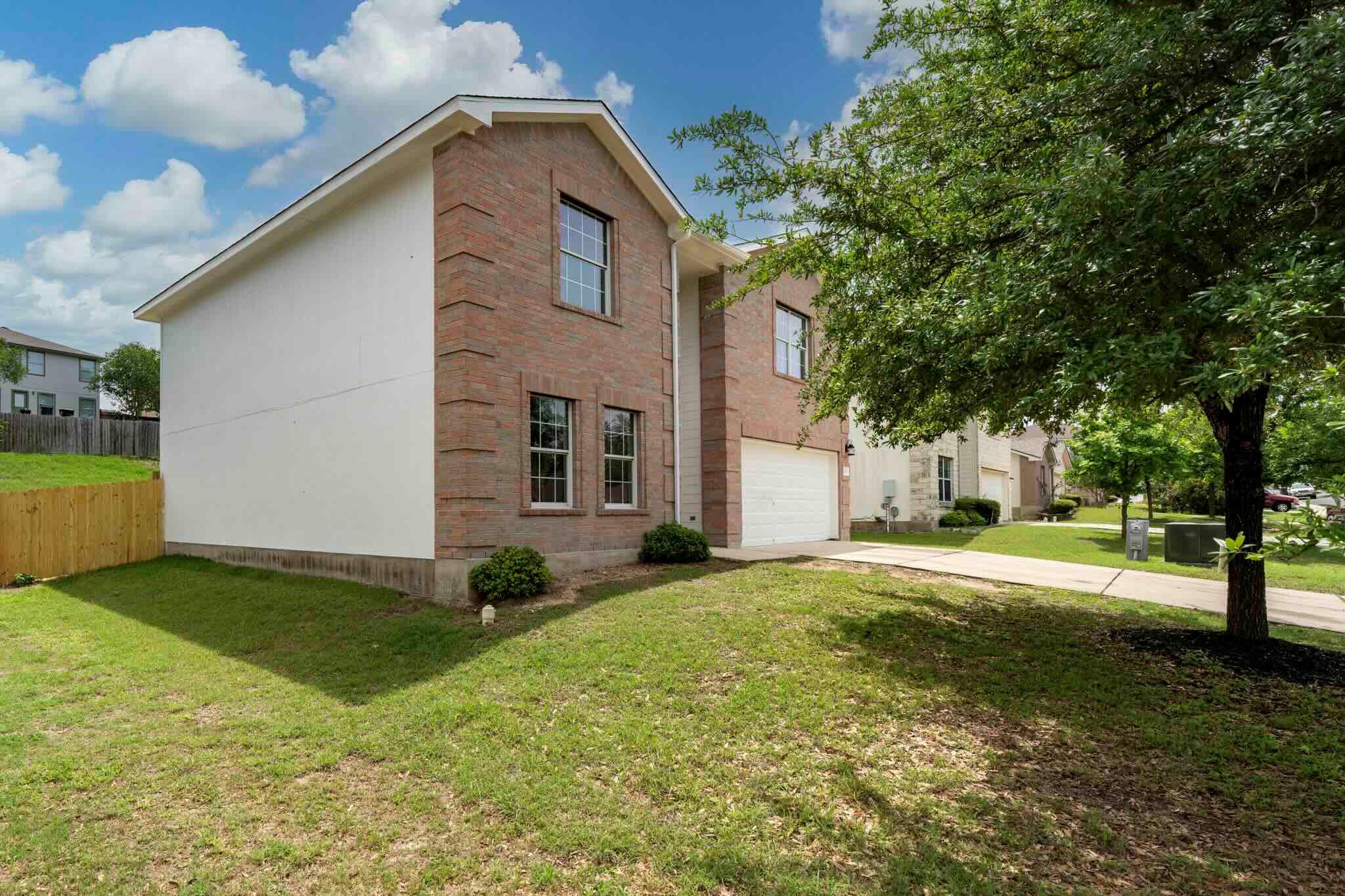 Two-story residence featuring brick and siding ex