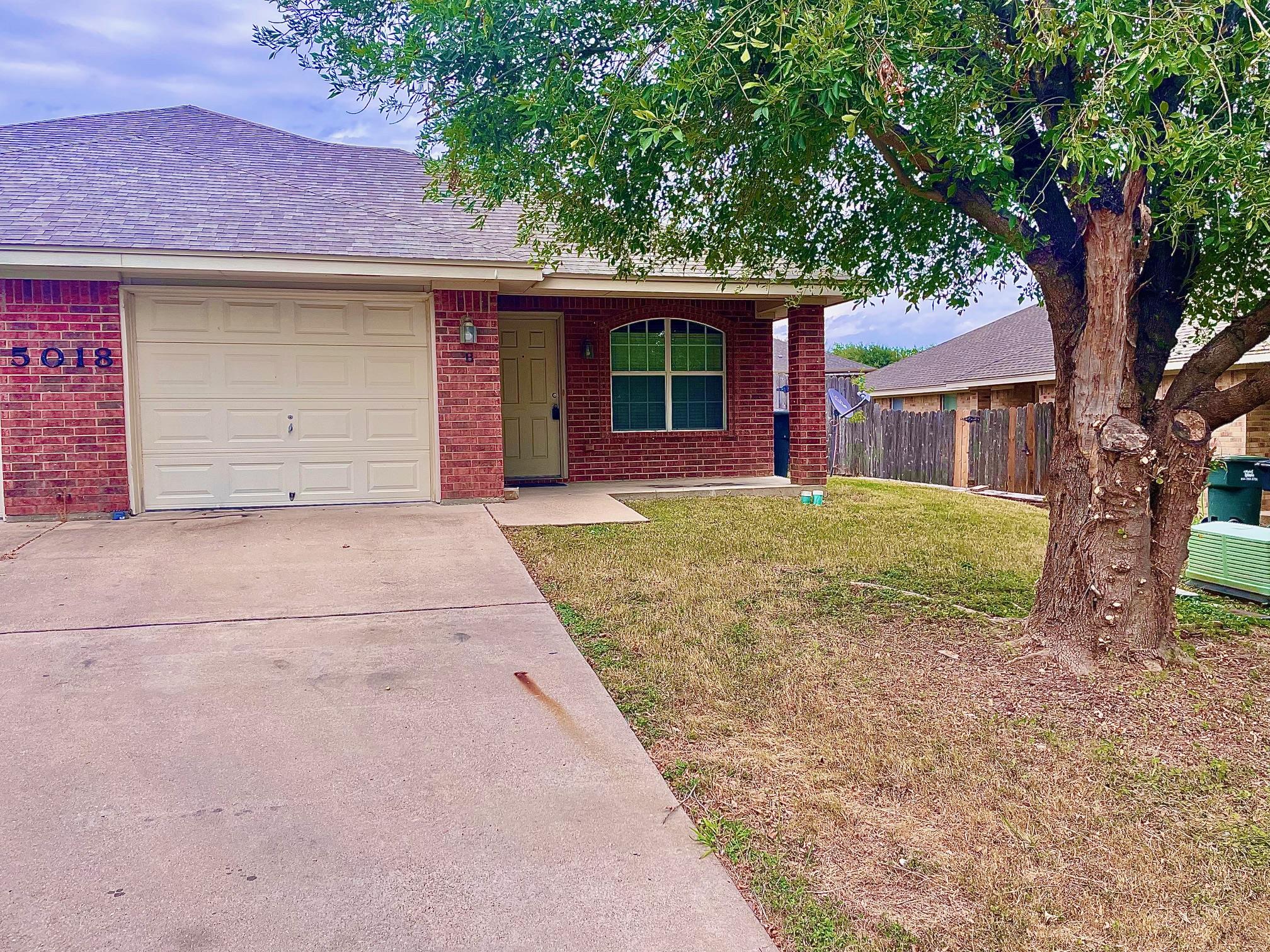 The property features a brick exterior, an attach