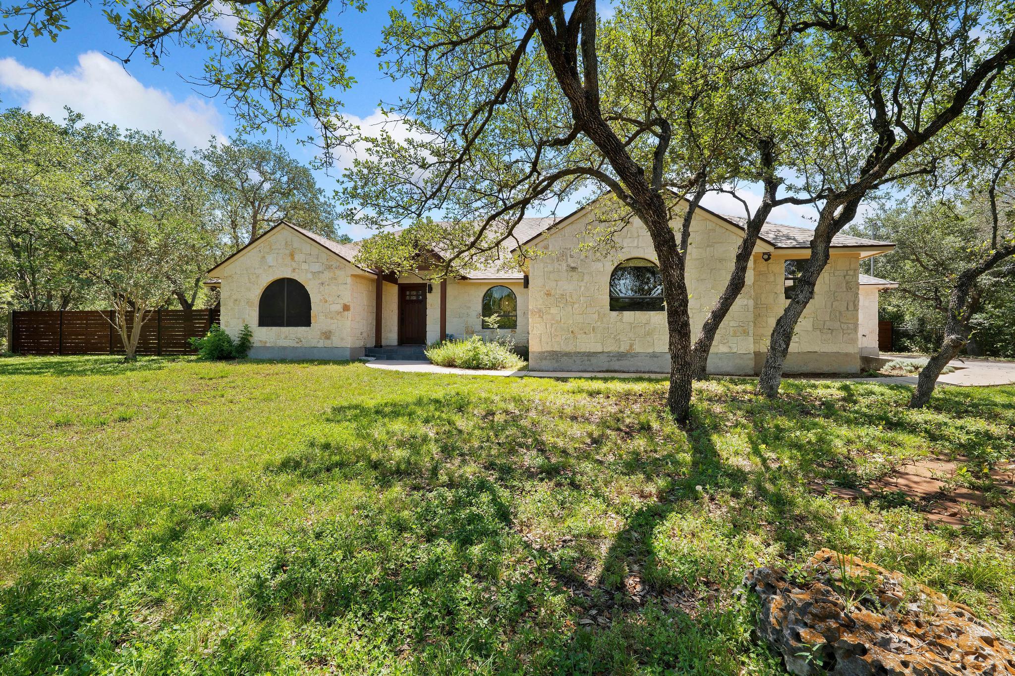 Stone veneer exterior with arched windows and a d