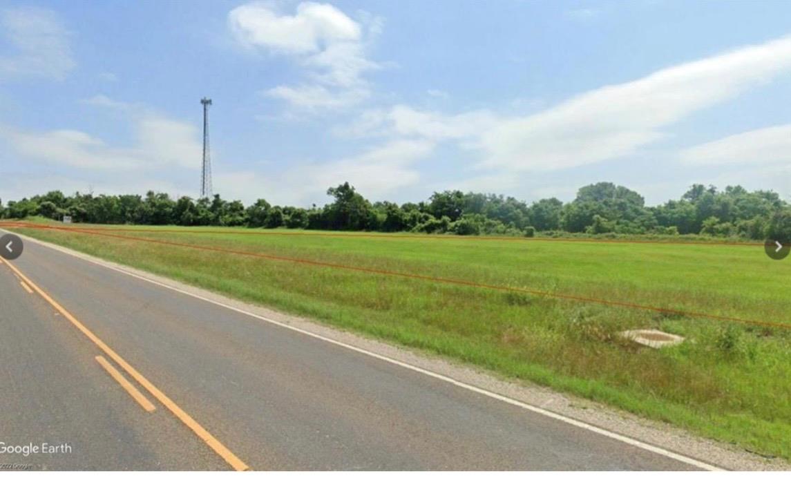 The property features an expansive green field wi