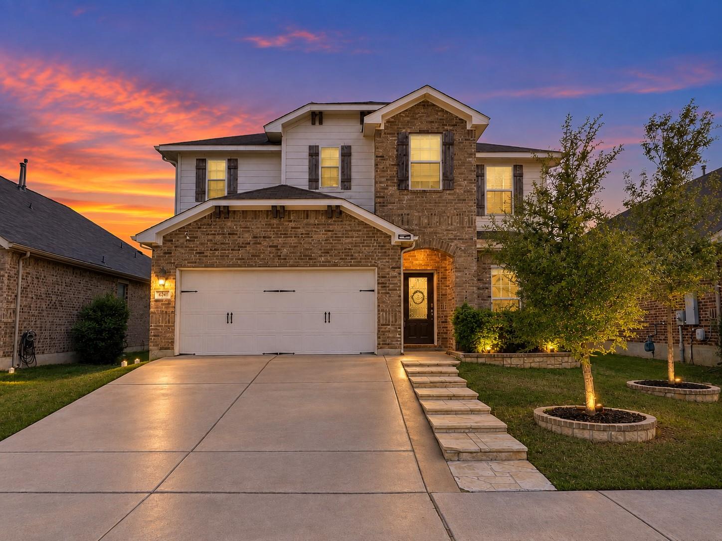 An inviting stone and siding exterior welcomes gu