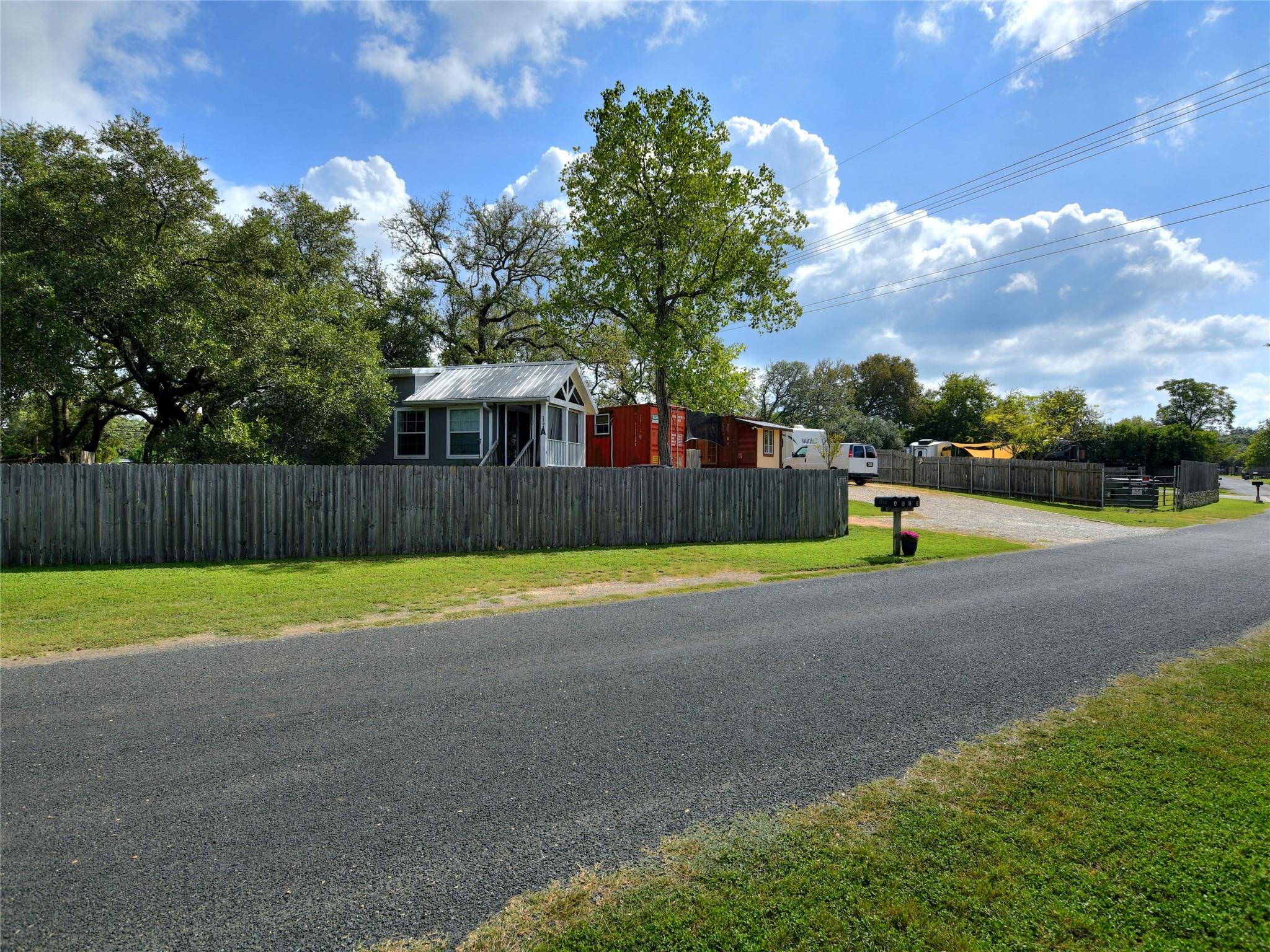 The property features a private fence and a grave