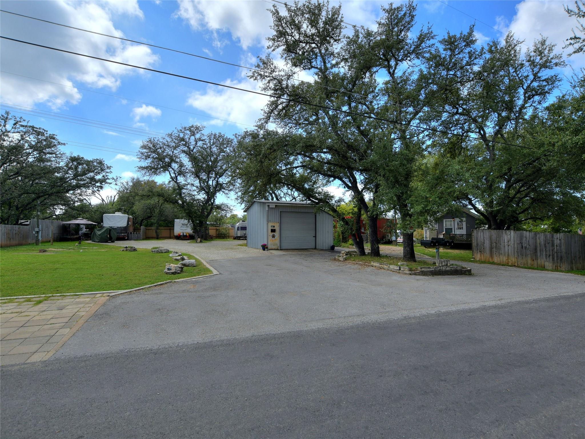 The property features a spacious paved area, a ma