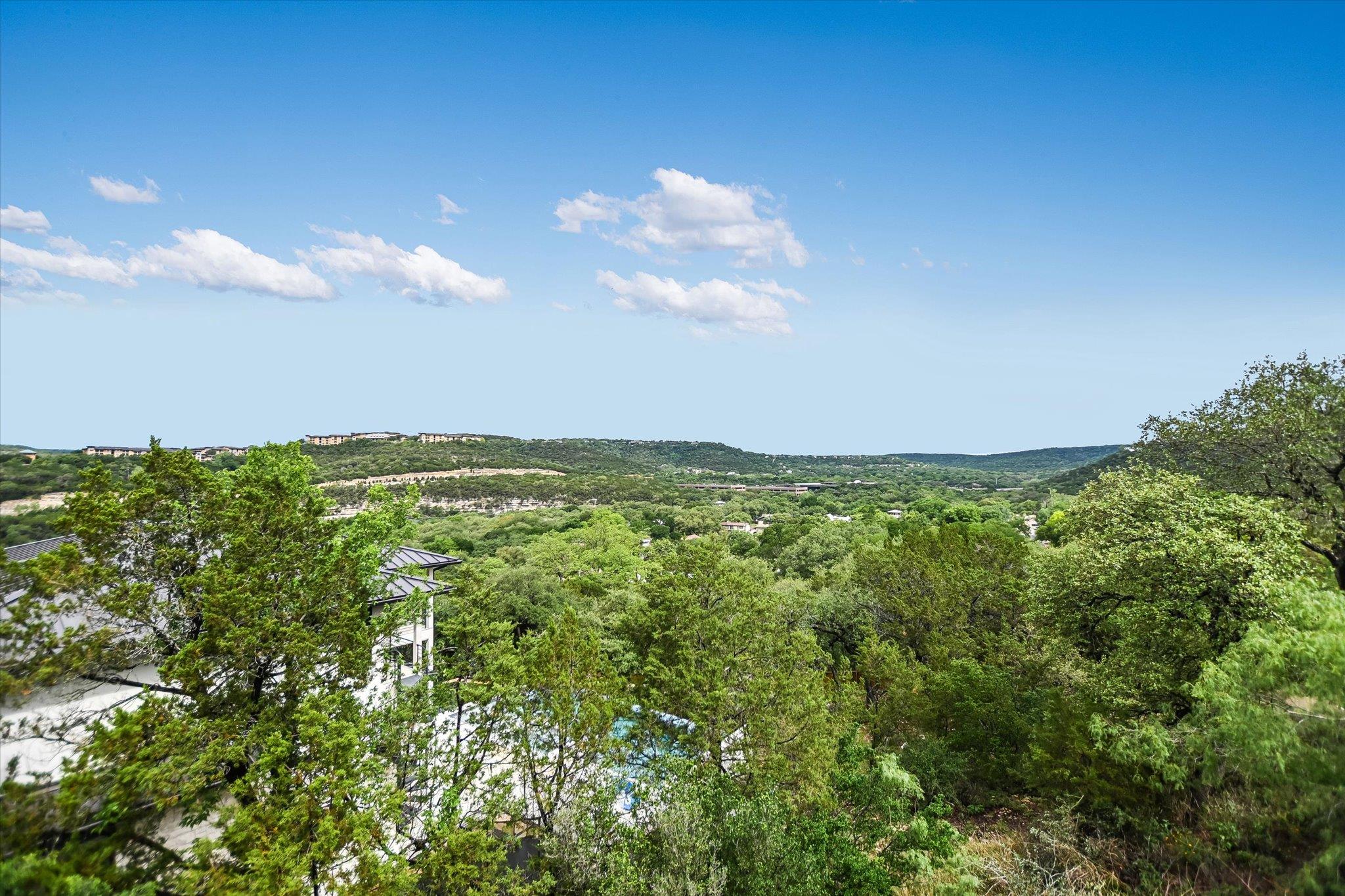 Expansive landscape featuring rolling hills and a