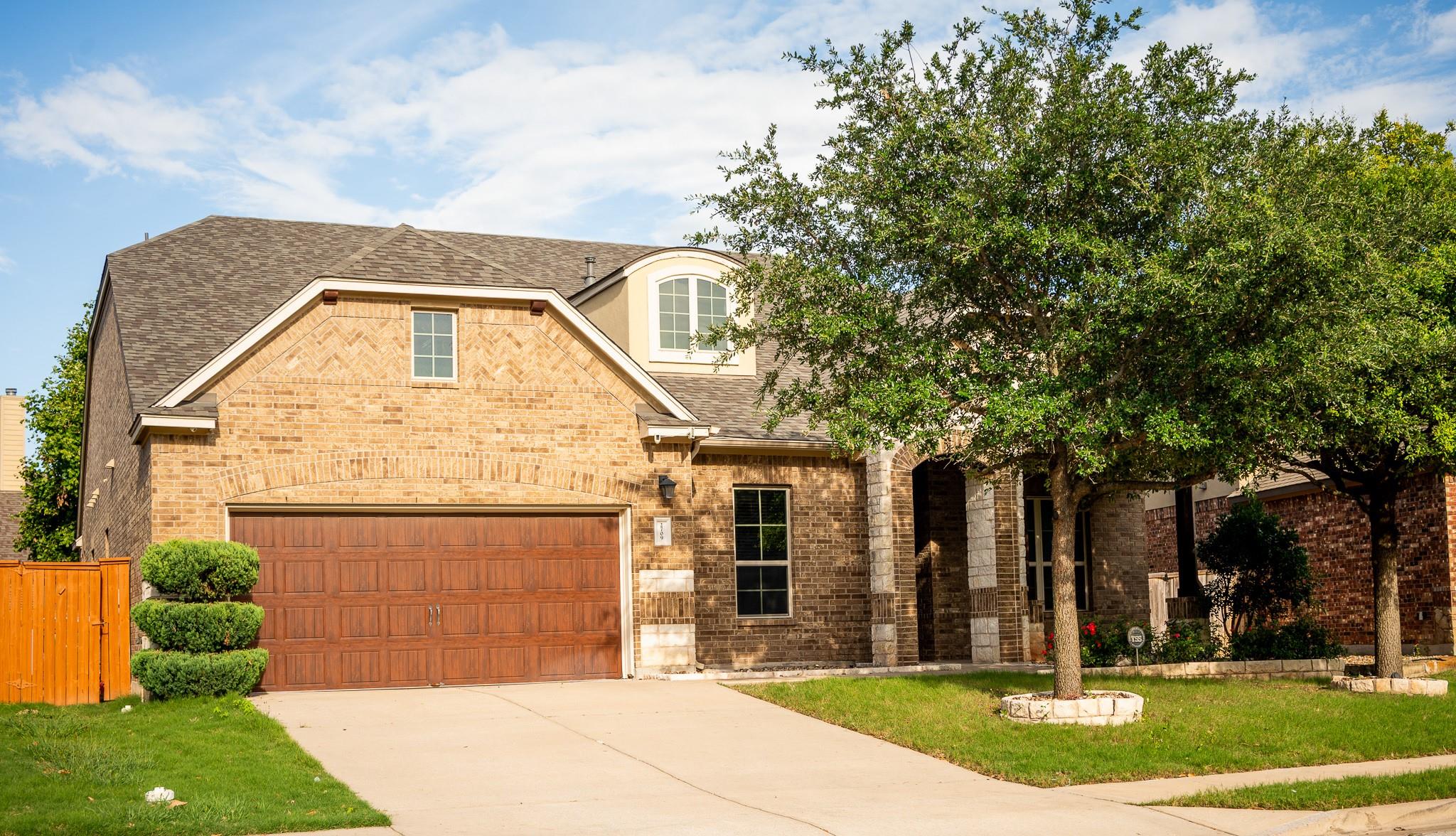 A classic brick facade and arched entry define th