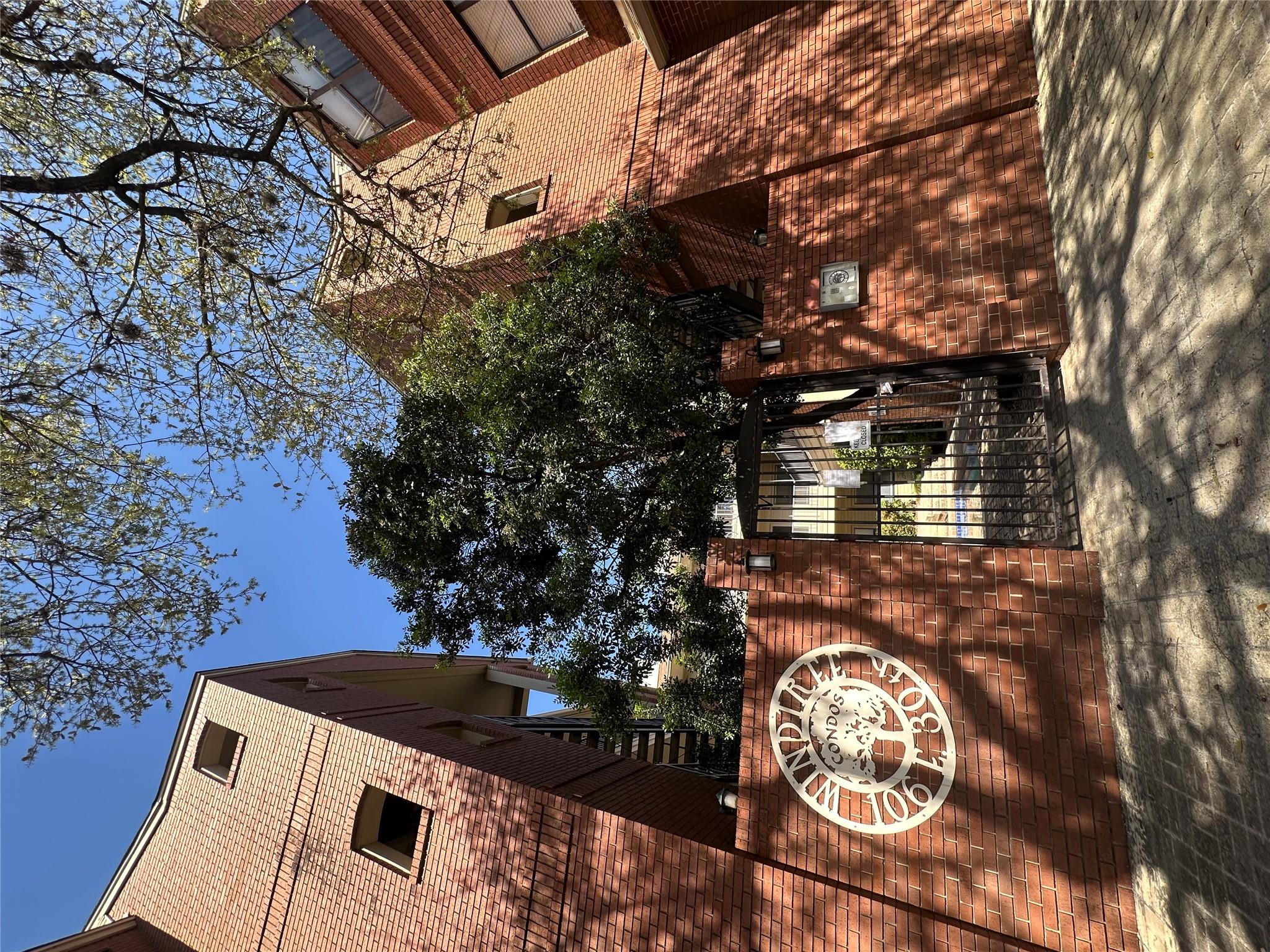 A secure, brick-clad building entry welcomes resi