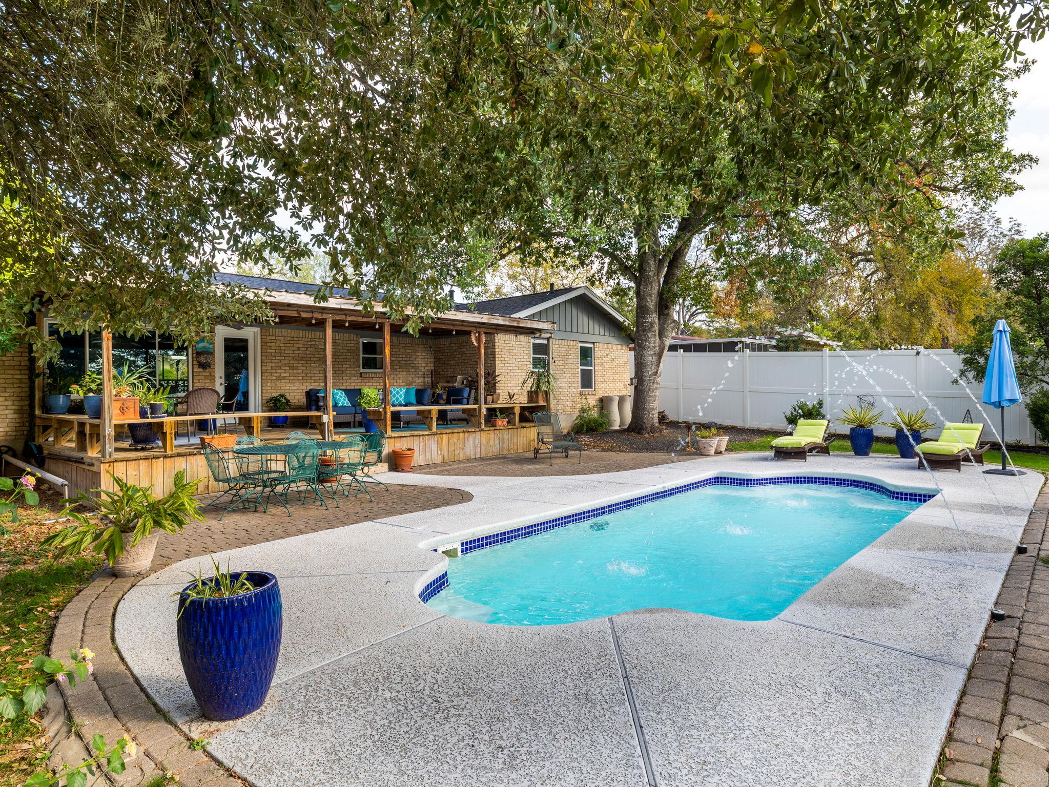 Backyard oasis featuring an in-ground swimming po