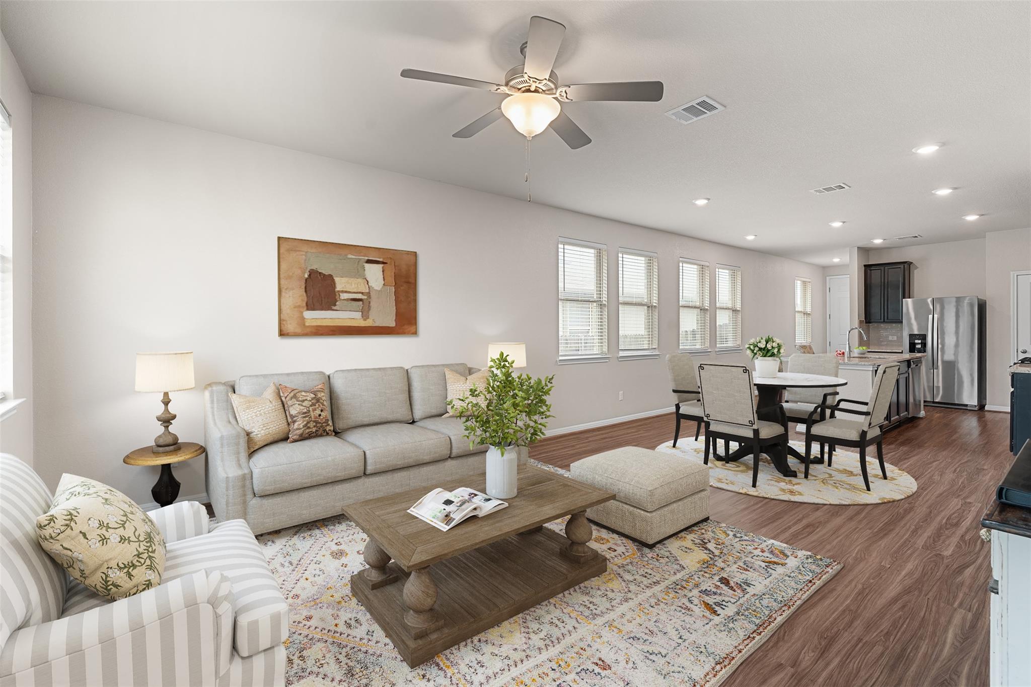 Open-concept living area featuring wood-finish fl