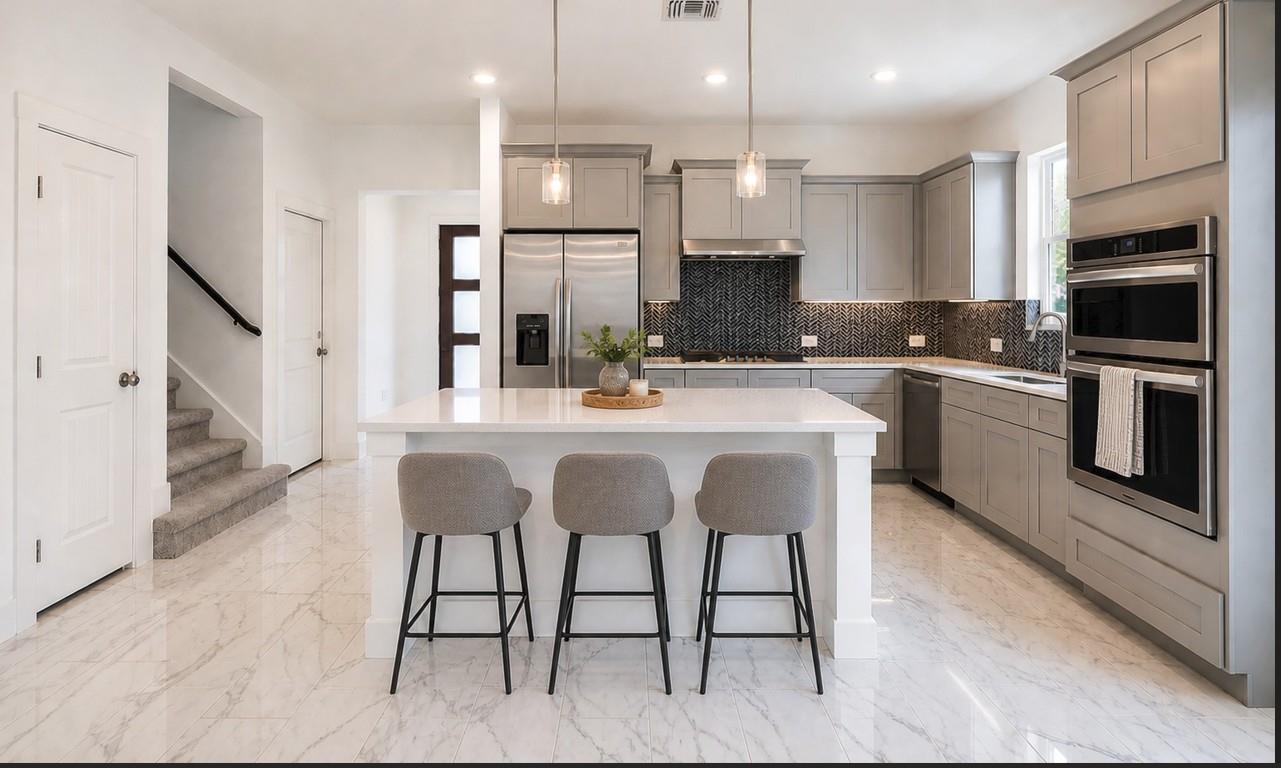 Modern kitchen featuring a white countertop islan