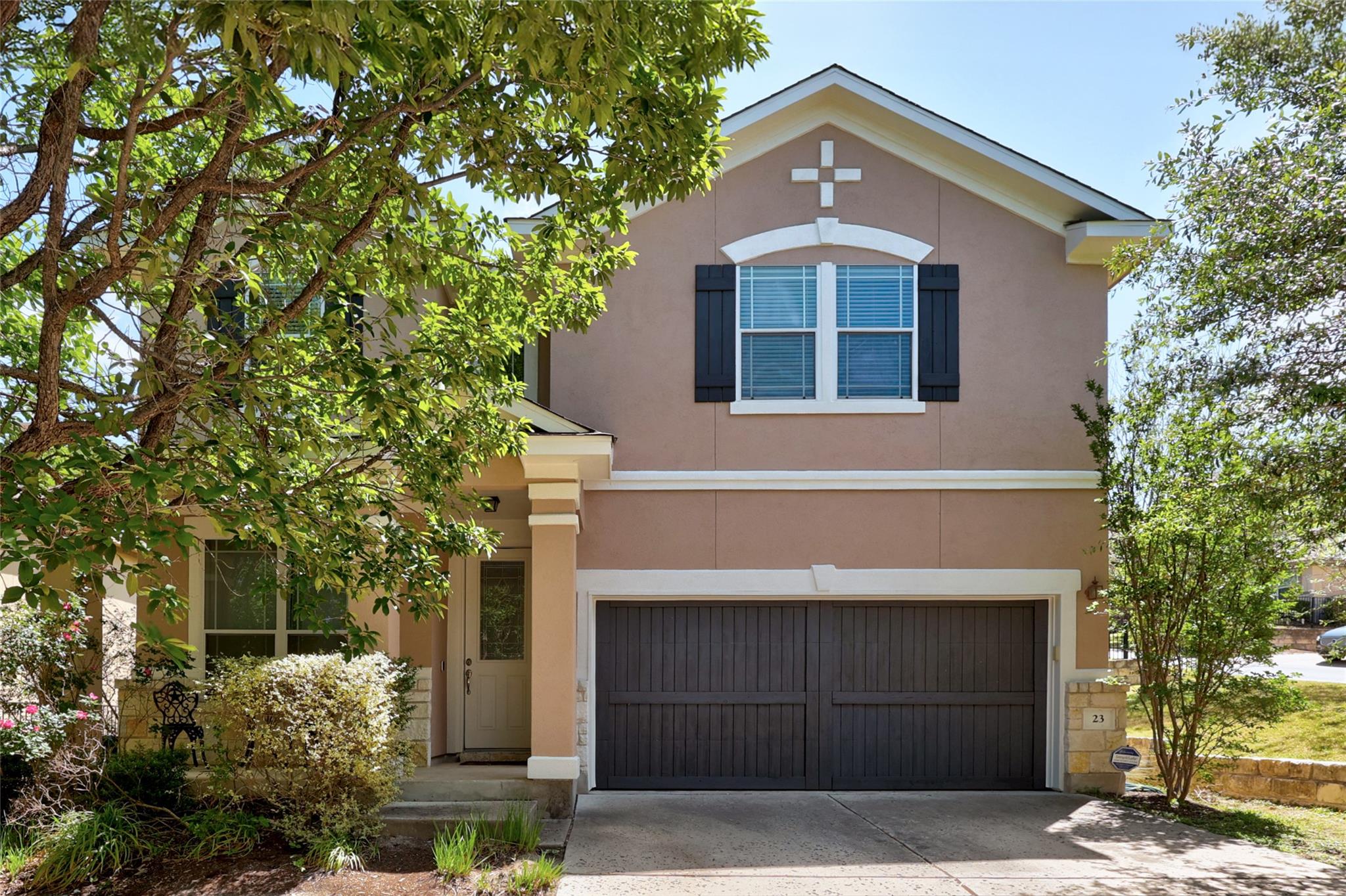 Two-story stucco exterior featuring an attached t