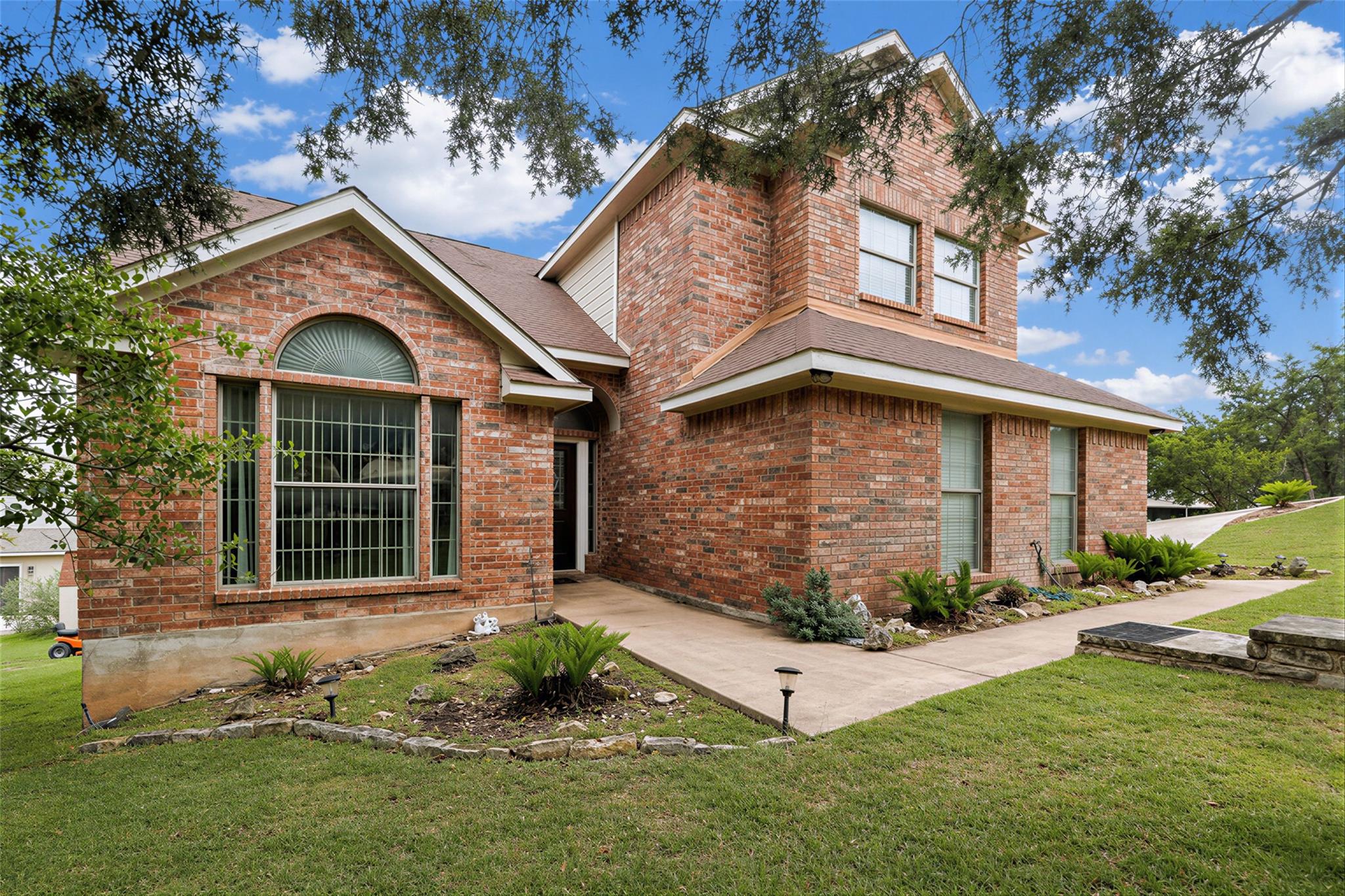 Brick exterior with a prominent arched window and