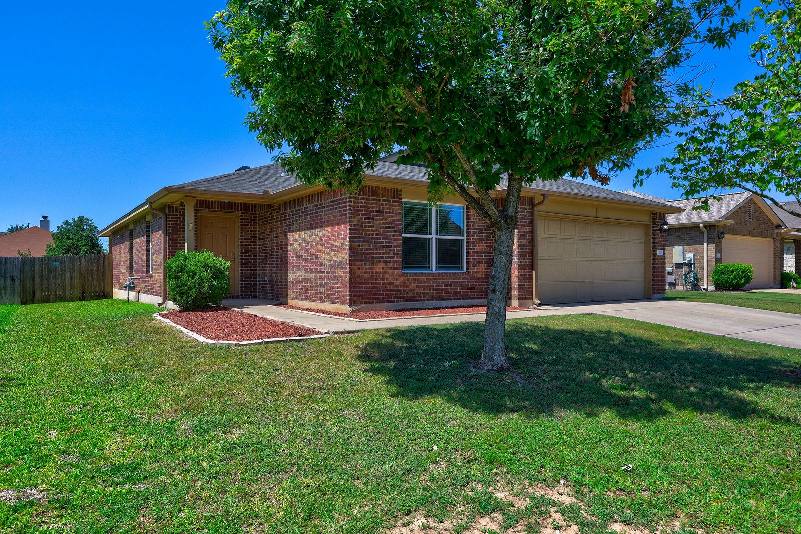 A classic brick exterior and a well-kept lawn wel