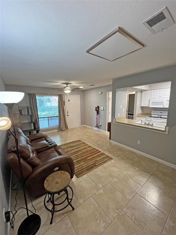 Open-concept living area with large-format tile f