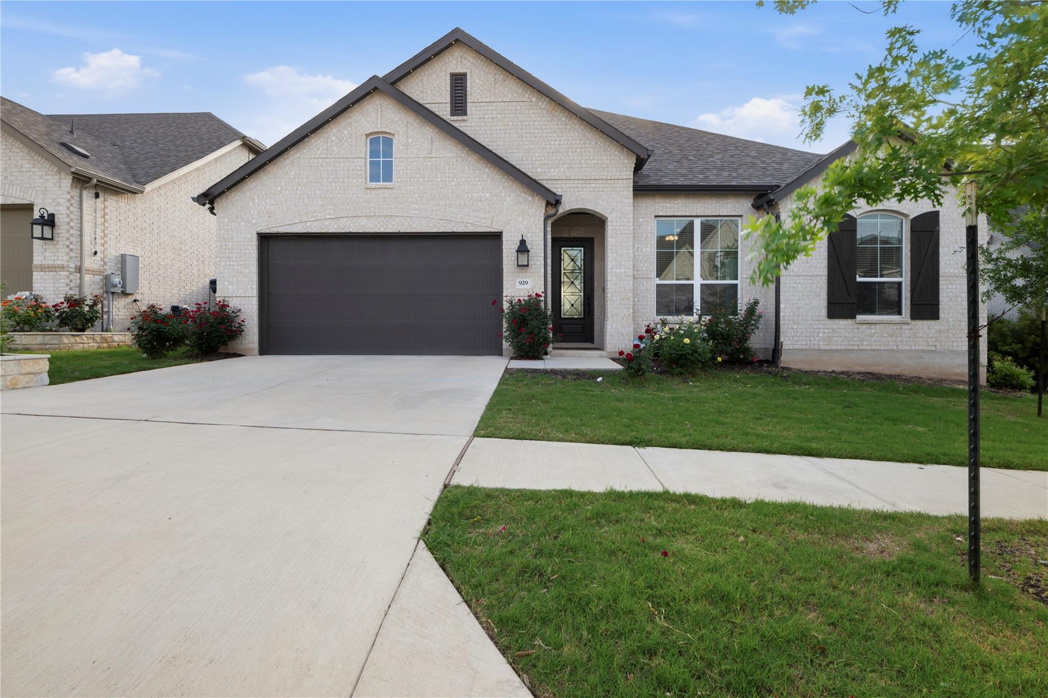 Light brick exterior featuring a dark garage door