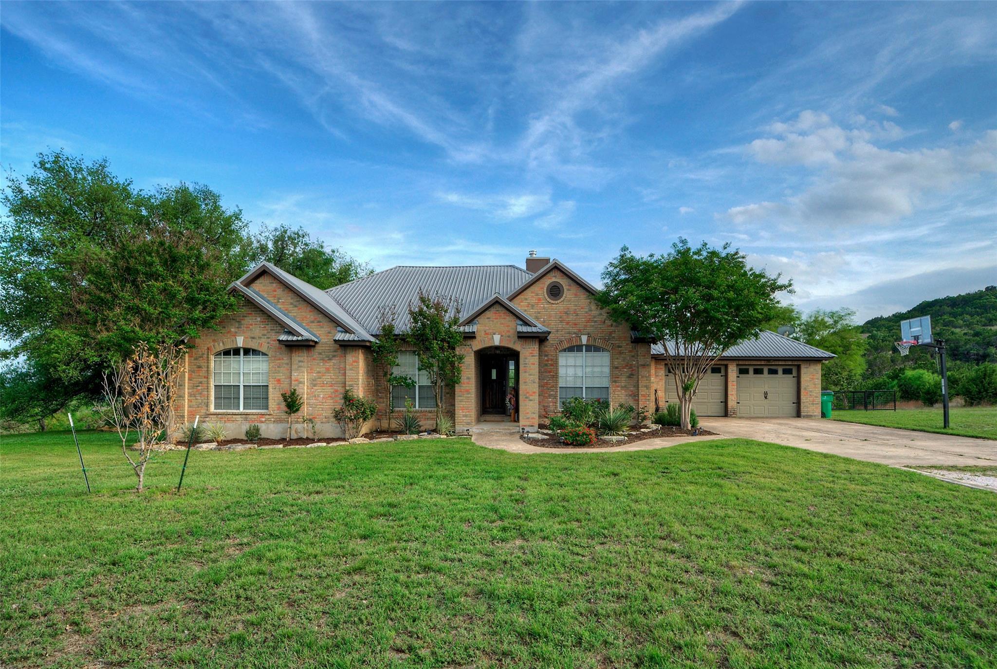 Brick exterior residence featuring a metal roof, 