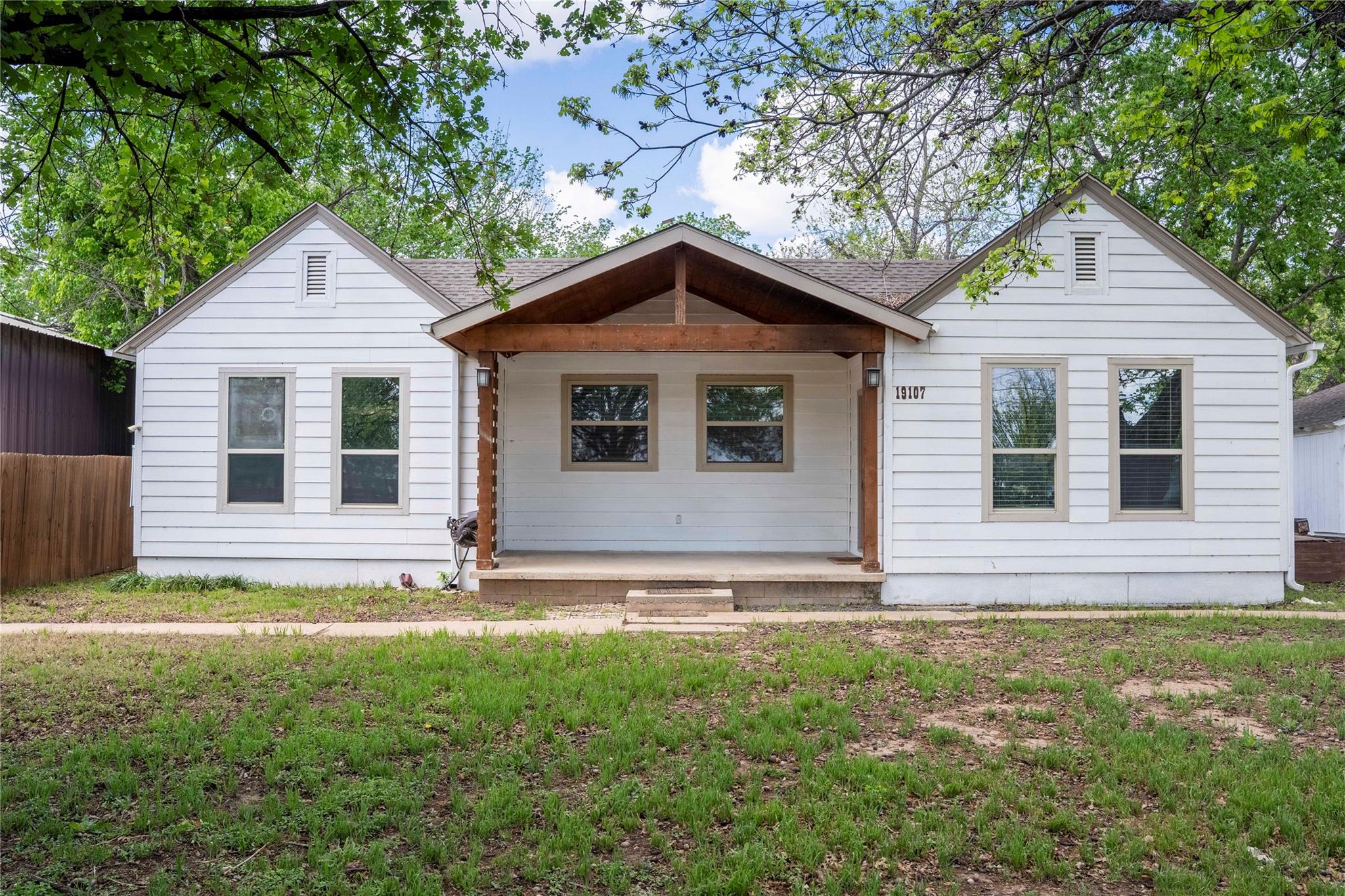 White horizontal siding exterior with a central c