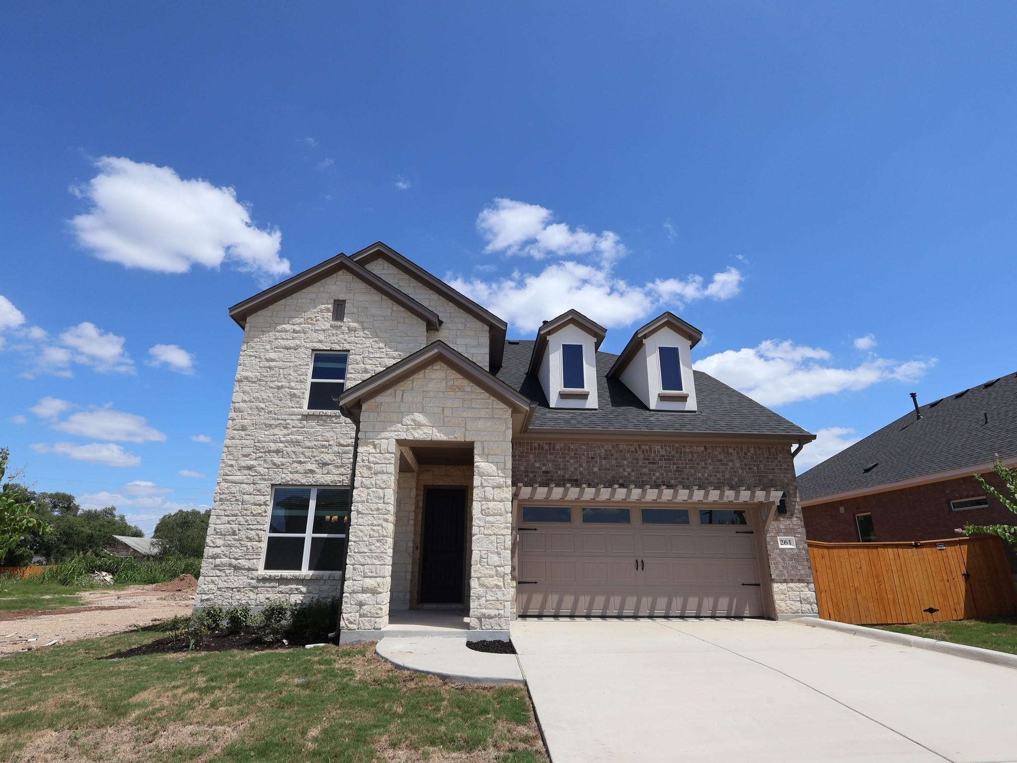 A newly constructed residence features a mixed-ma