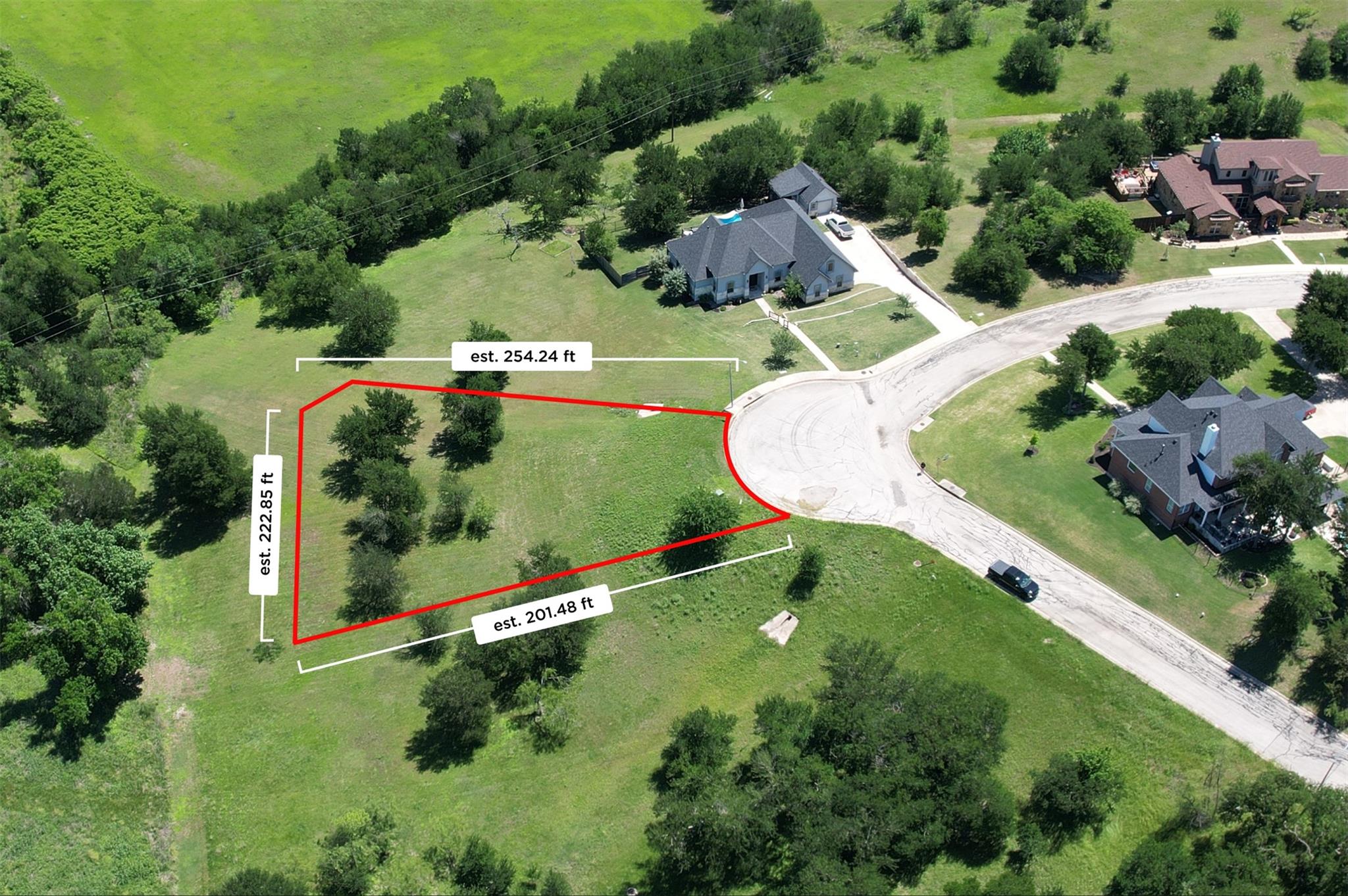 Expansive corner lot with mature trees, a gently 