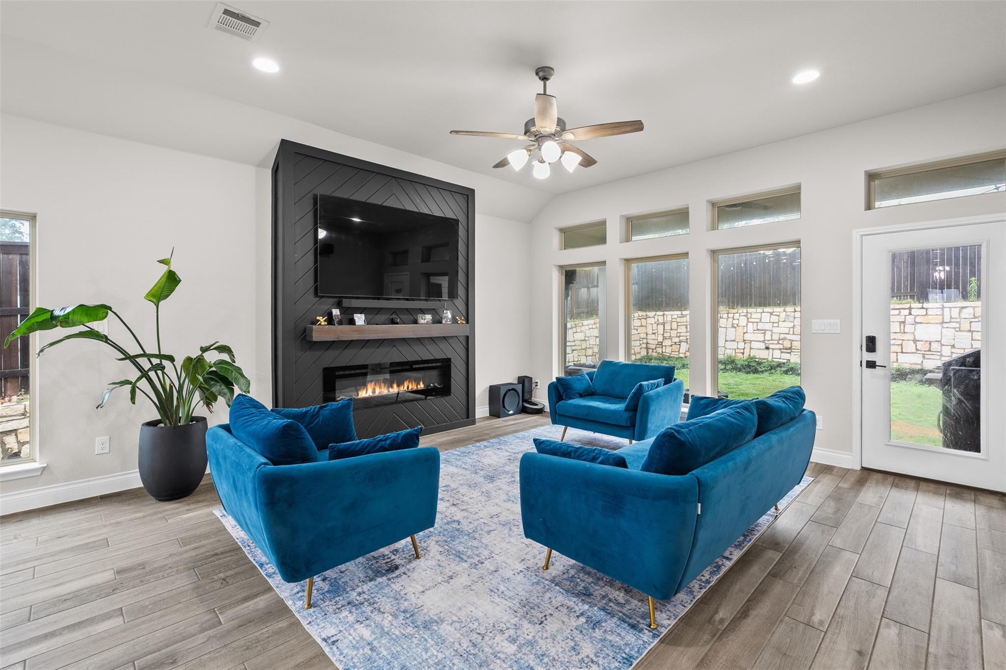 Open-concept living space featuring a modern fire