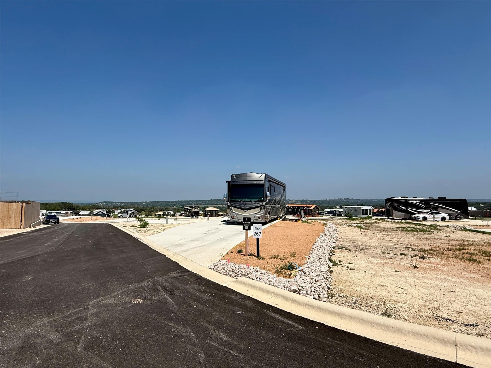 Paved RV pad with a graveled border, site marker,