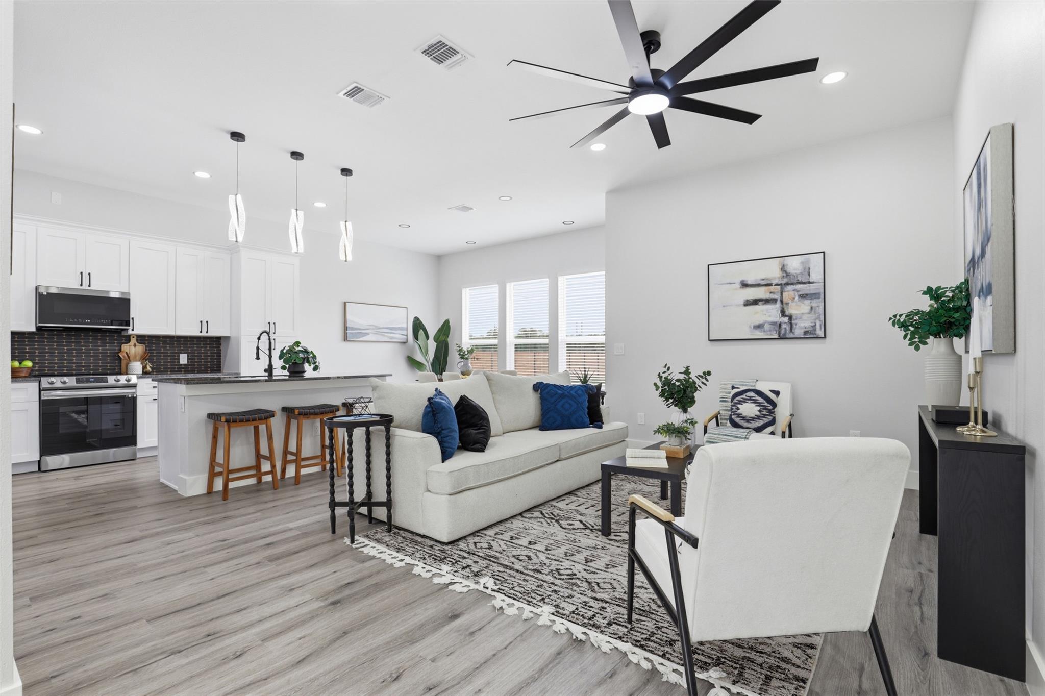 Open-concept living space featuring wood-finish f