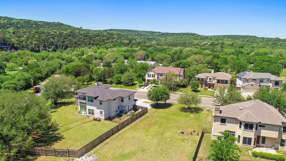 Spacious backyard with a wood privacy fence, matu