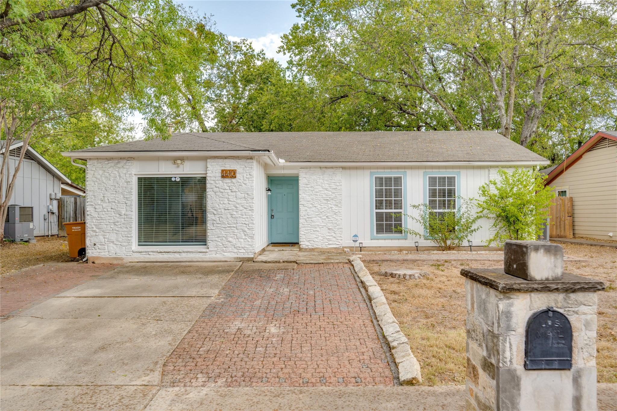 White textured exterior with a contrasting teal e