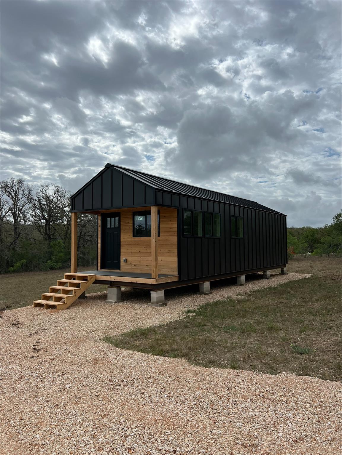 Modern black metal siding with natural wood accen