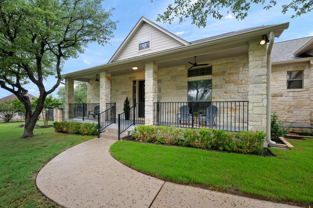 Stone veneer facade featuring a covered front por